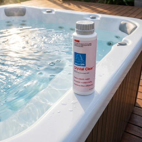 A bottle of BioGuard SPA Crystal Clear hot tub water clarifier sitting on the white acrylic edge of a sunny outdoor spa. The label outlines its benefits: clears cloudy water, restores crystal clarity, and improves filter efficiency for hot tubs.