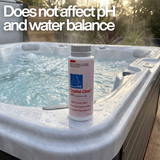 A bottle of BioGuard SPA Crystal Clear water clarifier sitting on the white corner of a bubbling outdoor hot tub. A prominent white text overlay states, "Does not affect pH and water balance," highlighting that the hot tub clarifier treats cloudy water without disrupting water chemistry.