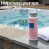 A bottle of BioGuard SPA Defence stain and scale control specialty treatment sitting on the edge of a clear blue hot tub 