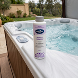1L BioGuard Spa Perfect Balance bottle on a white acrylic spa shell with bubbling water, used to prevent pH bounce and stabilize water chemistry in outdoor hot tubs.