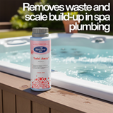 A 500ml bottle of BioGuard SPA Swirl Away pipe cleaner sitting on the wooden ledge of an active hot tub with bubbling water. Text overlay reads, "Removes waste and scale build-up in spa plumbing."