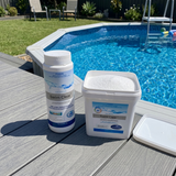 An open bucket of BioGuard Swim Clear showing the white soluble granules next to a 1kg bottle on a grey pool deck, used for sanitising above-ground swimming pools.