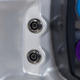 Two C-Helix 3 Directional SS spa jets installed vertically aligned in the contoured acrylic shell of a hot tub, showing their stainless steel bezels with black crescent accents against the silver-grey spa interior.