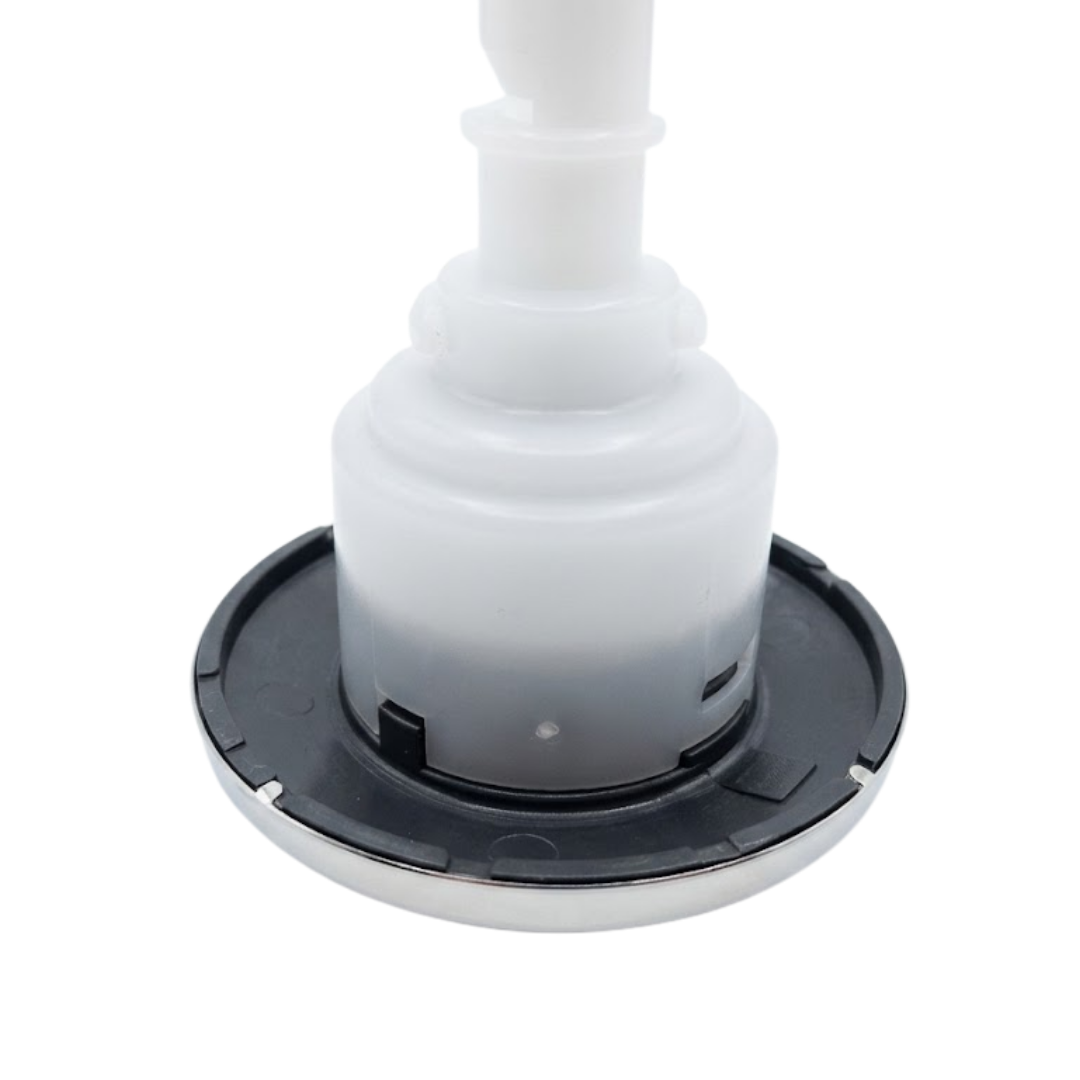 Close-up angled view of the rear housing and face flange on a C-Helix 3 MSSG SS spa jet internal insert, showing the dark grey back of the bezel with its stainless steel lip and white plastic body assembly.