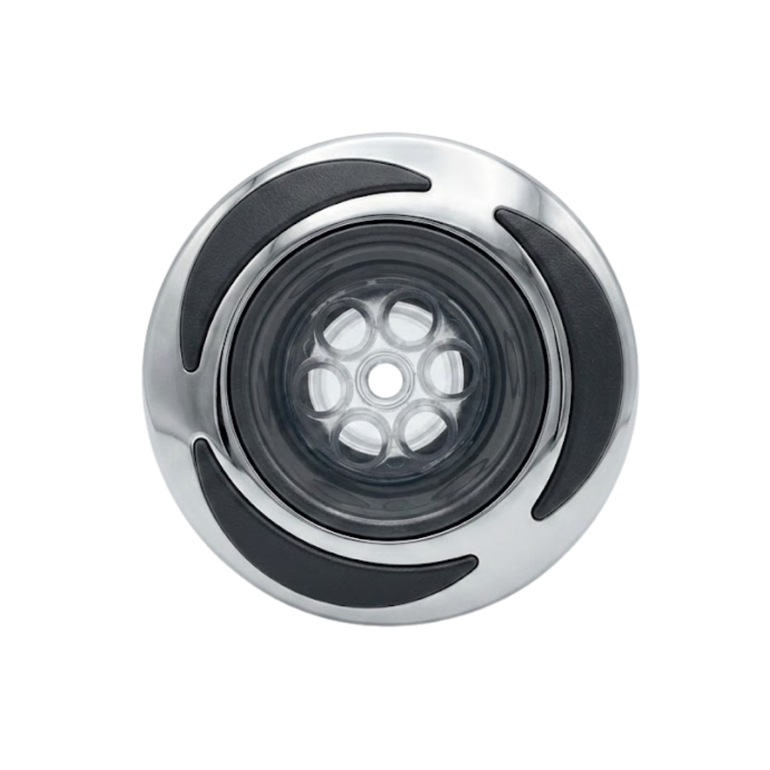 Direct overhead front view of a C-Helix 3 MSSG SS spa jet internal insert, featuring a stainless steel bezel with three black crescent accents and a multi-port massage nozzle cluster set behind clear plastic.