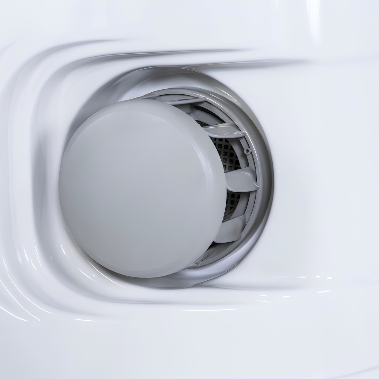 Close-up view of a gray CMP filter safety vane weir replacement cap fitted into a white acrylic hot tub skimmer assembly wall.