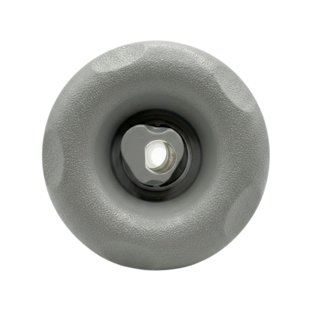 Direct overhead front view of a Cyclone Adj Swirl Emerald Large Face spa jet internal insert, featuring a textured light grey scalloped bezel and a central grey rotational swirl nozzle.