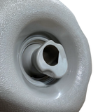 Close-up view of the central rotational swirl nozzle on a Cyclone Adj Swirl Emerald Large Face spa jet internal insert, showing its sculpted light grey head set inside a textured scalloped bezel.