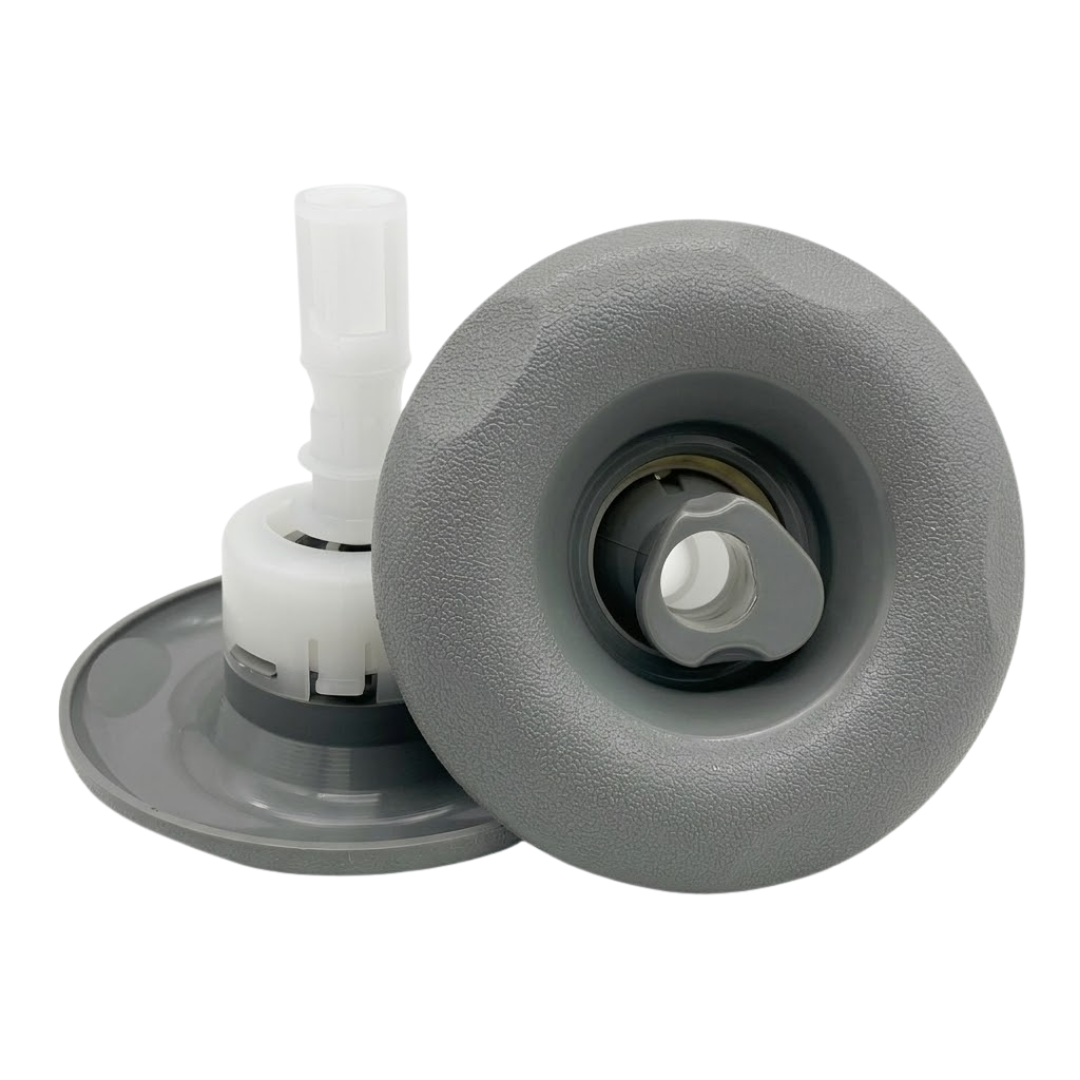 Two Cyclone Adj Swirl Emerald Large Face spa jet internal inserts, one displayed in side profile showing its grey face flange, white body, and stem, and one displayed front-facing showing its textured light grey scalloped bezel and rotational swirl nozzle.