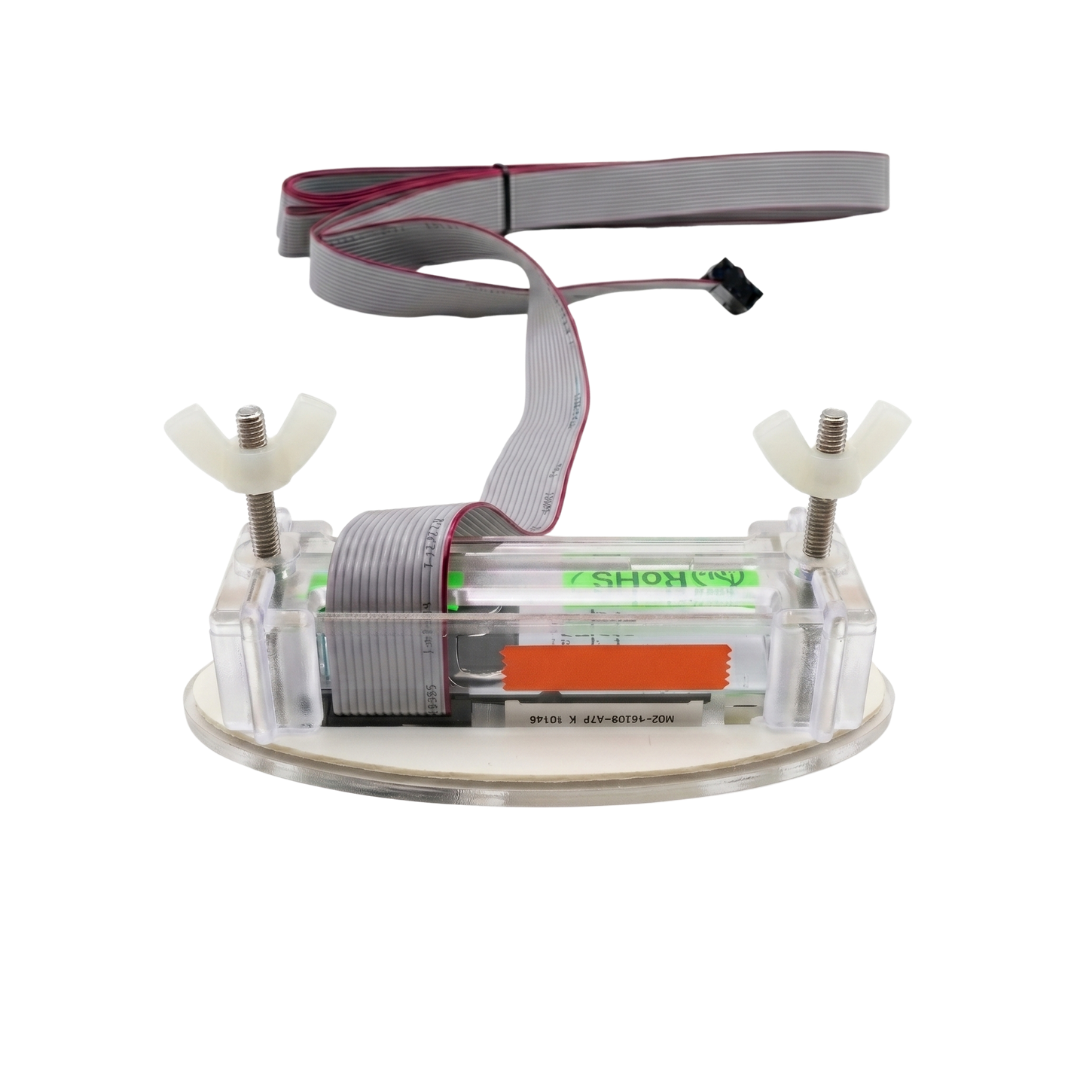Rear perspective view of a Davey SP601 oval spa controller touchpad, showcasing the clear protective plastic casing, twin mounting thread bolts with white plastic wing nuts, and an attached grey flat ribbon data connection cable.