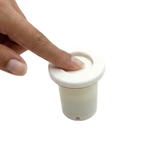 A hand using a finger to press down and activate a white Edgetec spa pneumatic air button switch on an upright cream colored cylinder housing