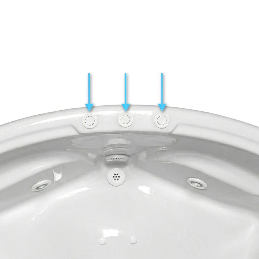 An overhead view of three white Edgetec spa air buttons installed in a row along the top rim of a white acrylic bathroom spa pointed out by blue arrows