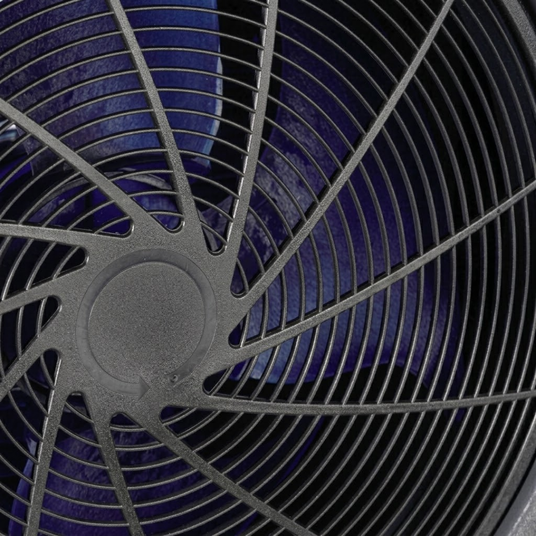 Extreme close-up view of the circular front fan grille and blue fan blades of an EvoHeat Force iPro series pool heat pump, highlighting the spiral plastic protective mesh and the directional rotation arrow on the center hub.