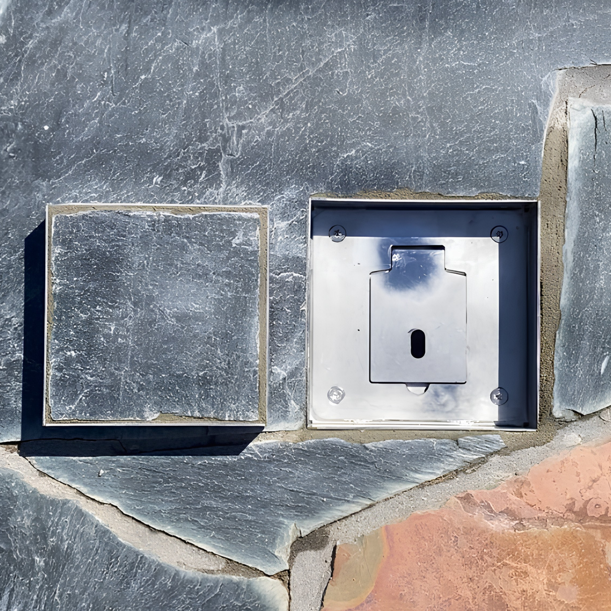Top-down view of an EzyHold Insert flush-mount umbrella holder base installed in natural stone slate paving, shown next to its matching slate-filled insert lid.