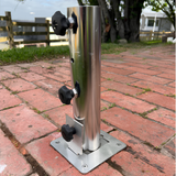 Heavy-duty stainless steel EzyHold umbrella mount sleeve featuring three black locking knobs bolted securely into an outdoor brick paver patio floor