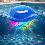 Blue floating waterproof Bluetooth speaker with an illuminated multicolored LED diamond-faceted underwater disco light show floating in pool water.