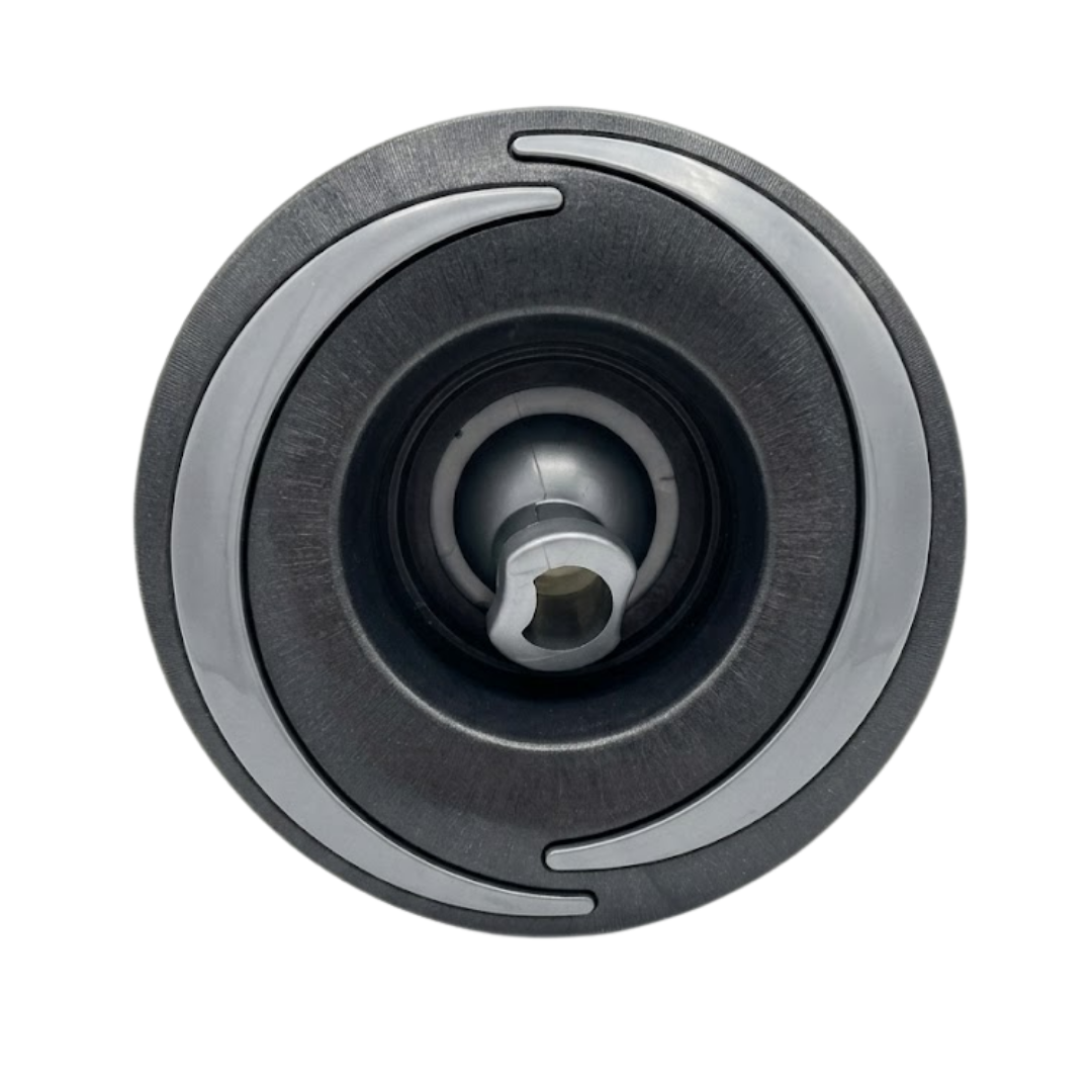 Direct overhead front view of a Halo 4.5 ROTO plastic spa jet internal insert, featuring a dark textured face with two curved light grey accent arcs and a central directional rotational nozzle.