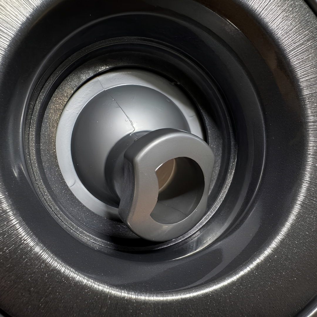 Close-up view of the central nozzle on a Halo 4.5 ROTO plastic spa jet internal insert, showing its dark grey rotational eyeball nozzle housed within a textured circular bezel.