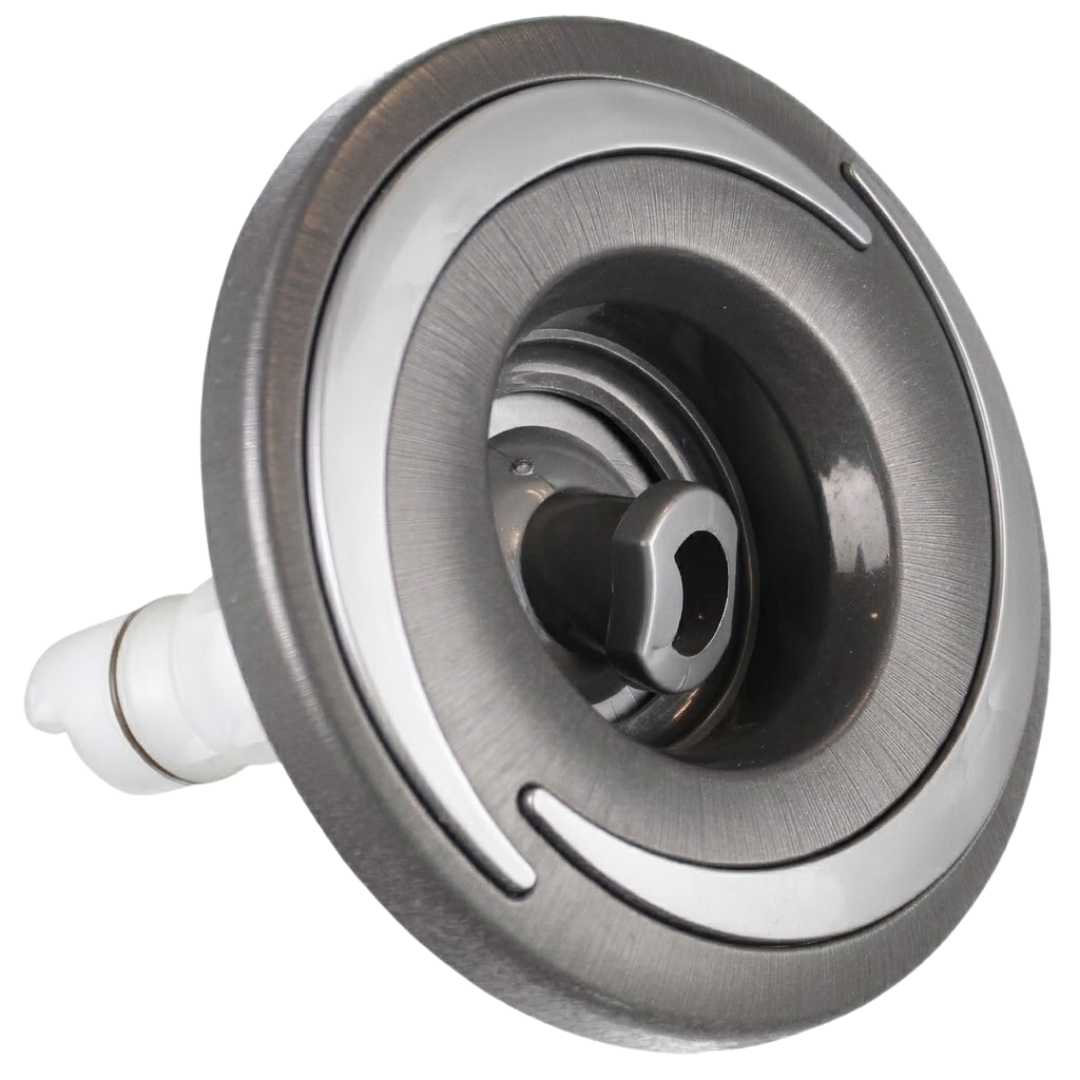 Three-quarter angled studio view of a Halo 4.5 ROTO plastic spa jet internal insert, featuring a dark brushed-finish circular bezel with silver crescent accents, a central rotational nozzle, and an extending white plastic rear stem.