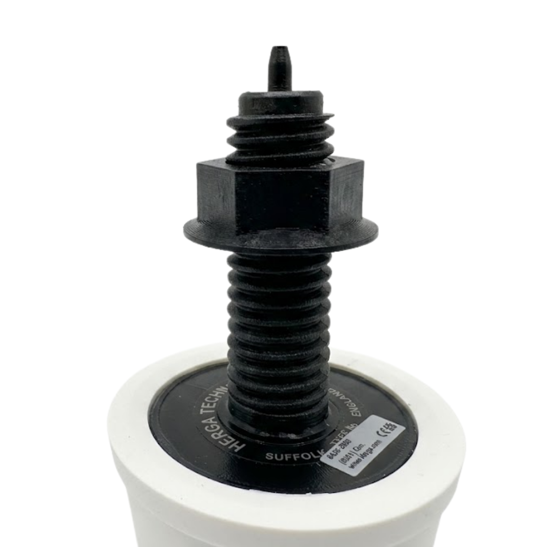 A close up inverted view of the black plastic threaded stem on a white Herga spa air button showing the hex lock nut, product sticker label, and the pneumatic hose barb tip