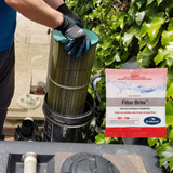 Pool professional wearing safety gloves removing a dirty swimming pool cartridge filter next to a sachet of BioGuard Filter Brite chemical cleaner.