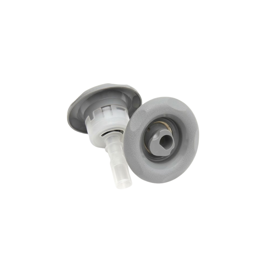 Dual product view of two Jet Cyc Luxury Adj Swirl Emerald 3.5 spa jet inserts, displaying one jet angled to show the translucent white body stem alongside a second jet showing the direct front face with textured scalloped grey bezel and central swirl nozzle.
