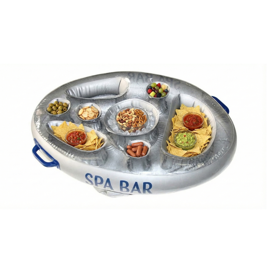 An inflatable silver Life Spa Bar floating tray isolated on a white background, viewed from a high angle. The tray features dark blue side handles and is loaded with party snacks including tortilla chips with salsa and guacamole, mixed nuts on ice, pretzels, cocktail sausages, olives, crackers, and a small bowl of mixed berries.
