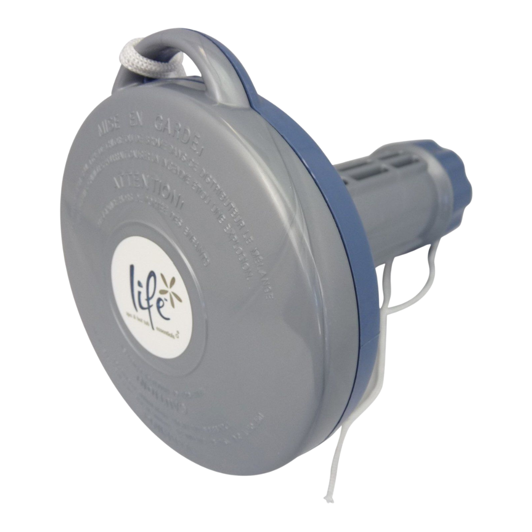A studio product shot of a gray and blue Life Spa Essentials floating hot tub chemical dispenser, shown from a side perspective on a white background. The image details the round cap with a white Life logo sticker, an integrated top handle threaded with a white tie-off string, and the adjustable slotted tablet basket extending to the right