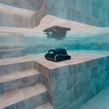 Underwater shot of the Maytronics Dolphin Liberty 200 robotic pool cleaner resting on a wide, tiled pool step bench near built-in stairs.