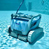 Underwater action shot of the blue Maytronics Dolphin M 600 robotic pool cleaner operating on a tiled pool floor, showing its blue power cable attached, dual active scrubbing brushes, and front LED indicator.