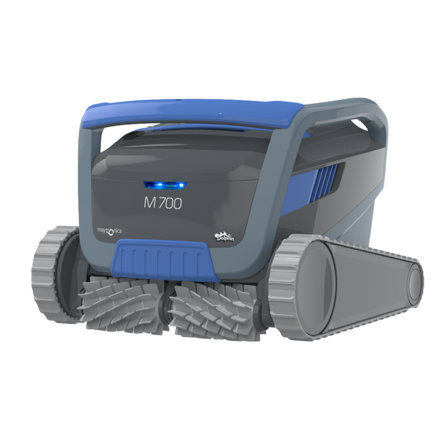 Studio product view of the Maytronics Dolphin M 700 robotic pool cleaner on a white background, featuring a dark grey casing, blue accent handle and panel, dual active scrubbing brushes, and side tracks.