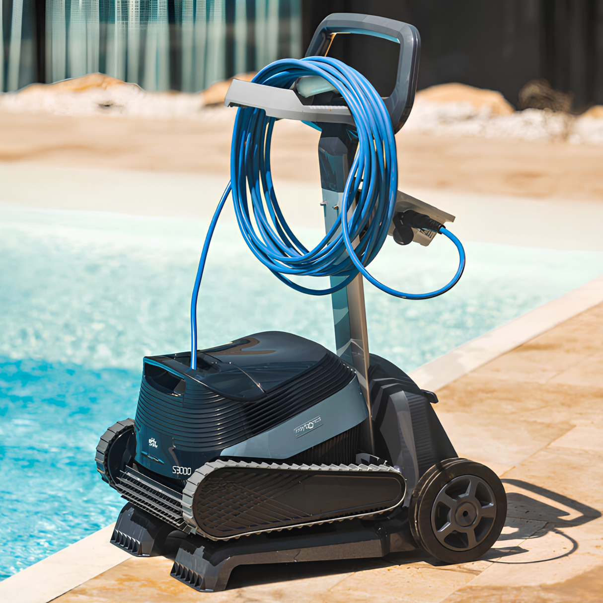 Maytronics Dolphin S3000 robotic pool cleaner stored on its transport caddy cart with a coiled blue power cable poolside.