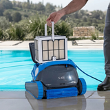 Poolside lifestyle view of a person lifting the top-access fine filter basket out of the dark grey and blue Maytronics Dolphin S 400 robotic pool cleaner.