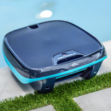 Maytronics Dolphin Skimmi solar-powered pool skimmer robot sitting on a tiled pool deck next to water.