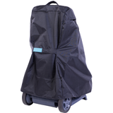 Rear three-quarter studio view of a black weather-resistant protective cover draped over a Maytronics Dolphin pool cleaner transport caddy on an isolated white background, detailing its light blue securing tab strap, top grab handle, vented upper seams, and exposed dark grey caddy base with dual wheels.