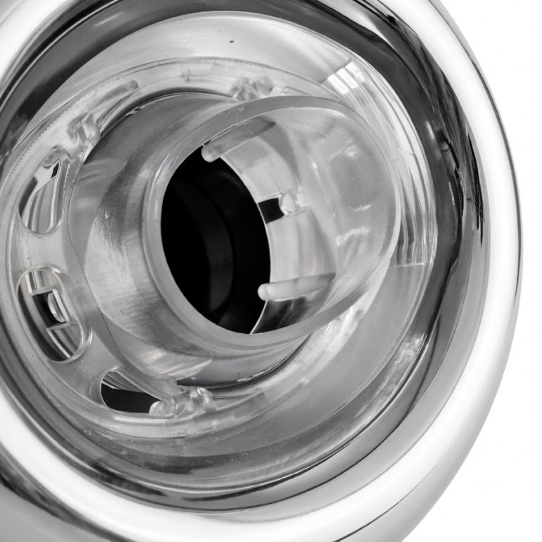 Close-up view of the clear plastic nozzle barrel and internal housing on an Ovo Swim With Metal 2in SX 12in Artesian spa jet insert, framed by a smooth stainless steel outer bezel.