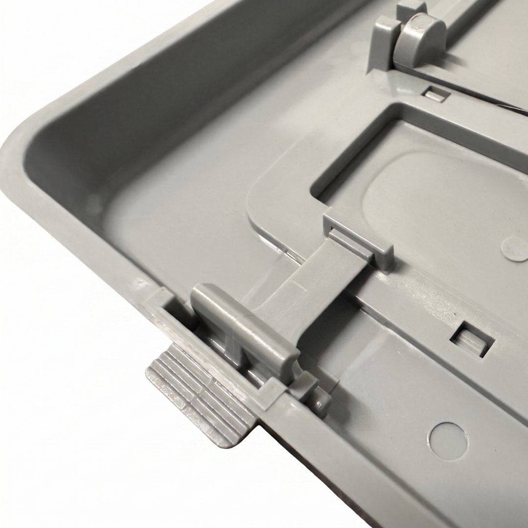 Macro close-up view of the grey plastic snap-in hinge clips and pivot tabs on the reverse side of a wide mouth pool skimmer weir door assembly