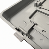 Macro close-up view of the grey plastic snap-in hinge clips and pivot tabs on the reverse side of a wide mouth pool skimmer weir door assembly