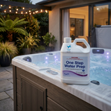 A 2.5L bottle of Poppits One Step Water Prep with the Sensitive Choice logo resting on a premium wood-paneled hot tub edge at dusk, with overhead string lights in an outdoor patio.