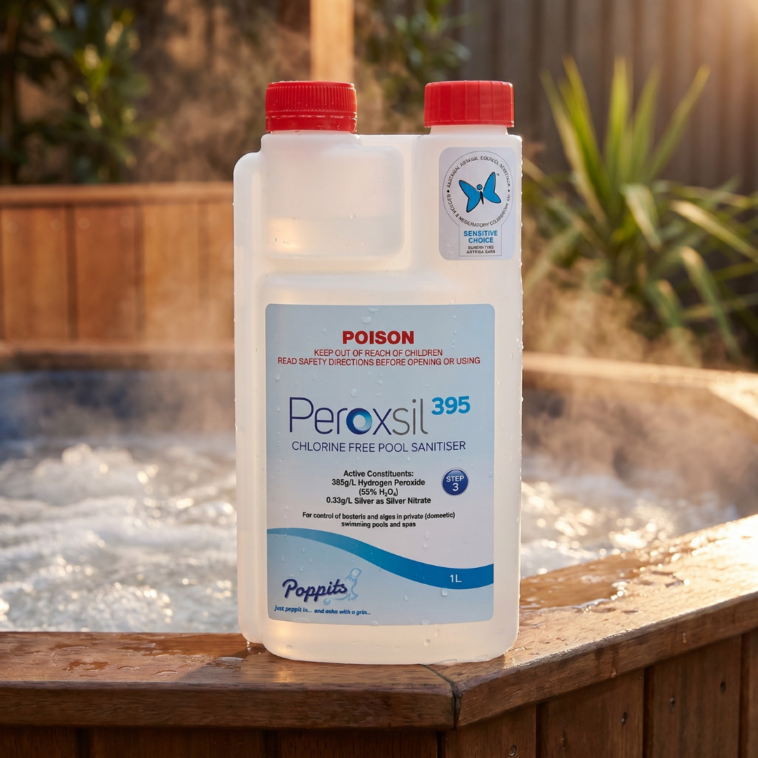 A 1L bottle of Poppits Peroxsil 395 Chlorine Free Pool Sanitiser on the edge of a steaming timber hot tub, featuring the Sensitive Choice blue butterfly logo for asthma and allergy care.