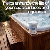 A 500g tub of Poppits Spa Cal Hardener on the wooden frame of a steaming outdoor hot tub. Large text overlay reads, "Helps enhance the life of your spa's surfaces and equipment," highlighting the benefit of raising calcium hardness levels.