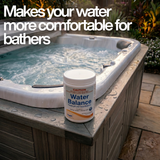 A tub of Poppits Water Balance chemical placed on the corner of an outdoor hot tub with steaming water. The text overlay reads "Makes your water more comfortable for bathers," and the product label shows it raises pH and Total Alkalinity using Sodium Bicarbonate.