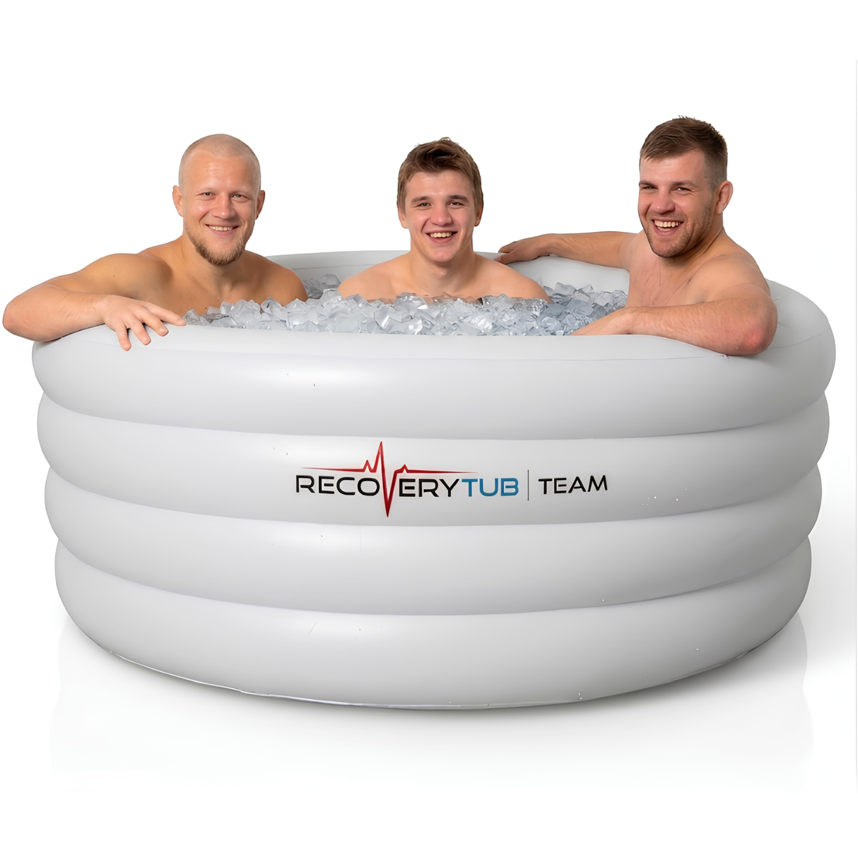 Three smiling male athletes sitting inside a large white inflatable RecoveryTub Team ice bath packed with ice cubes, showing the spacious capacity for group athletic cold therapy recovery against a clean white background.