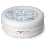 A round white inflatable RecoveryTub Team ice bath fully inflated and filled to the top with clear ice cubes, isolated on a white background.