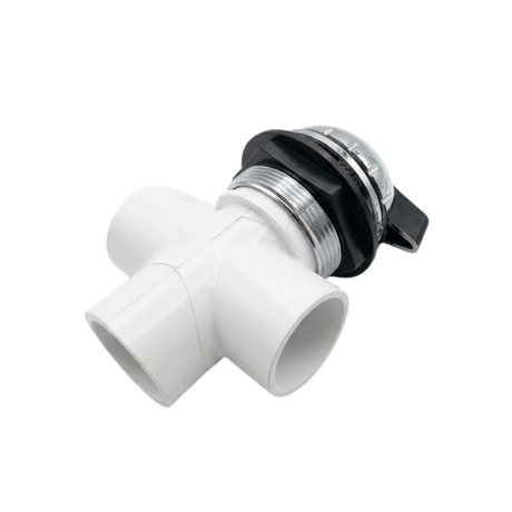 An inverted underside view of a small hot tub diverter valve showcasing the white plastic 3 way slip socket plumbing ports and black locking collar nut