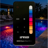 Close-up of a Spa Electrics iRIS remote control overlaid on an outdoor swimming pool at night with glowing multicolored LED underwater lights.