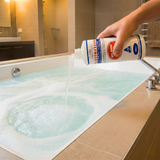 using a bottle of spa giene bathtub cleaner in a tiled bathroom.