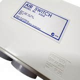Close-up angled view of the Space Age Electronics AS02 10A pool air switch label next to an embossed Gewiss GW 44 206 IP56 housing stamp.