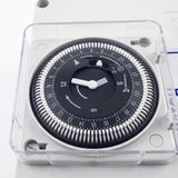 Close-up macro shot of the Intermatic 24-hour analog timer dial with white segment pins inside the Space Age Electronics AS02-T air switch controller.