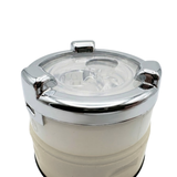 Close-up view of the top face of a swirl spa jet internal insert, showcasing a polished chrome bezel ring with three raised gripping tabs, a transparent plastic face cover, twin rotational jet nozzles, and an off-white lower housing.